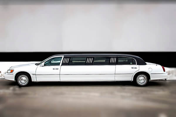 side view of a white limousine