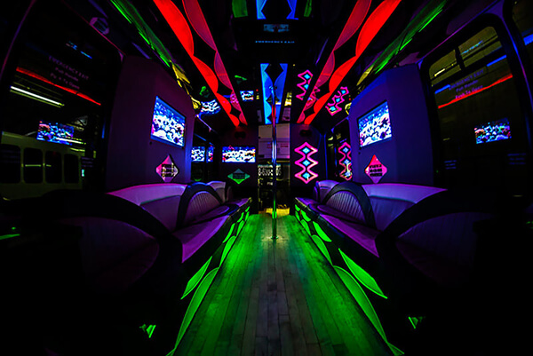 Green and red lights are bright on the inside of this party bus